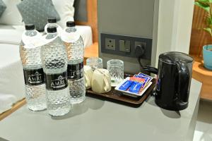 a table with two bottles of water and glasses at Hotel Sai Kamal in Shirdi