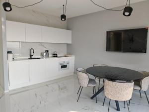 a kitchen with a black table and chairs at Sui Generis Montesilvano Colle in Montesilvano