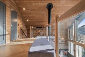a bench in the middle of a room with windows at Panoramahytte med fjellutsikt in Sogndal