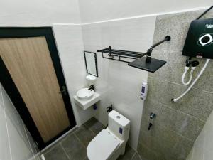 a small bathroom with a toilet and a shower at NitaDinn Guest House in Kampong Ru Sepuloh +21 photos
