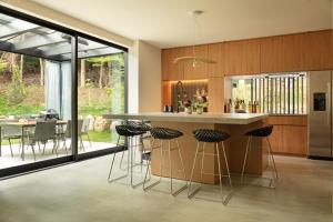 a kitchen with a large island with bar stools at hotel norm ao in Fujikawaguchiko