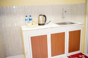 a kitchen with a sink and a counter top at Saka house in Banyuwangi