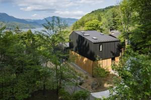 an overhead view of a black house with trees at hotel norm ao in Fujikawaguchiko