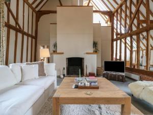 a living room with a white couch and a coffee table at Headland Barn in Maldon