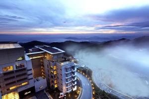 a foggy city with a building and the ocean at Highland Breeze Hotel in Genting Highlands