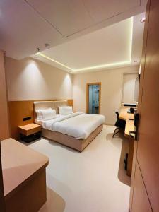 a hotel room with a bed and a desk at Nirvana Nest in Lucknow