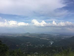 a view of a valley from a mountain with clouds at Hotel Chairman's Bungalow in Gurudeniya