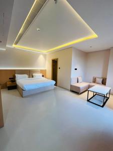 a hotel room with two beds and a couch at Hotel Nirvana Nest in Lucknow