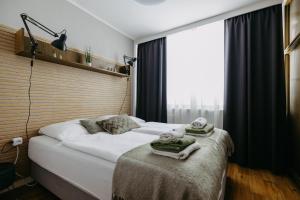 a bedroom with a bed with towels on it at Burgenland Hideaway in Bad Tatzmannsdorf +48 photos