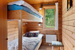 a bedroom with a bunk bed in a wooden cabin at OH456-Storvorde-Kystvej-173 in Storvorde