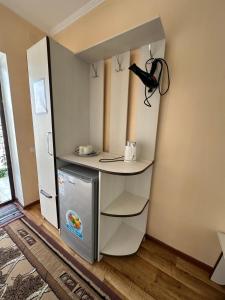 a small kitchen with a counter and a refrigerator at Boomerang Guest house in Cholpon-Ata +40 photos