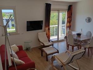 a living room with a red couch and a table and chairs at Modern and bright apartment in Rome