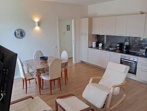 a kitchen and dining room with a table and chairs at Modern and bright apartment in Rome