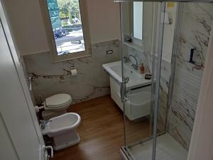a bathroom with a toilet and a sink and a shower at Modern and bright apartment in Rome +21 photos