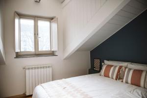 a bedroom with a white bed and a window at Regina 144 by RD Domus in Turin