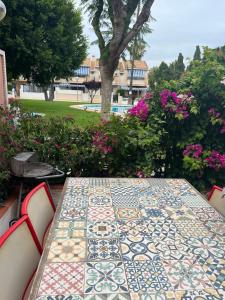 une table avec un motif de fleurs dessus dans l'établissement San Juan Beach Bungalow - Muchavista, à San Juan de Alicante 5 autres photos
