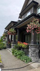 a house with flower boxes on the front of it at Carrie The Gentle Nest 1 in Coquitlam