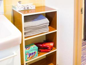 a towel rack in a bedroom with towels at Sunflower Hotel 703, Osaka, Namba & Shinsaibashi in Osaka
