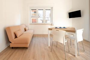 a living room with a table and a chair and a couch at Micenei Homes in Otranto