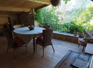 a patio with a table and chairs on a deck at Campagne de Pré Grand in Saint-Étienne-les-Orgues +45 photos