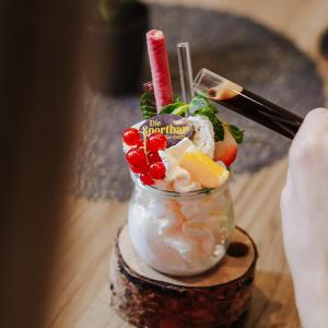 a dessert in a glass jar on a table at Die Sportbar in Rio Bianco