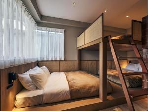 a bedroom with two bunk beds and a window at illi Mia Kinshicho in Tokyo