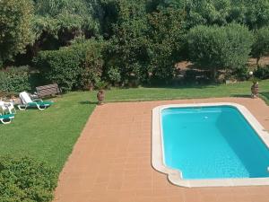 a swimming pool in a yard next to a garden at Castell del Montgrí Rural in Torroella de Montgrí