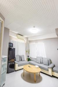 a living room with two couches and a table at Roppongi 3min Walk, Shinjuku 10min,Shibuya 15min, Tokyo Tower 58sqm for 6 in Tokyo
