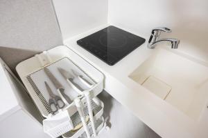 a kitchen counter with a sink and a dish drying rack at Roppongi 3min Walk, Shinjuku 10min,Shibuya 15min, Tokyo Tower 58sqm for 6 in Tokyo +48 photos