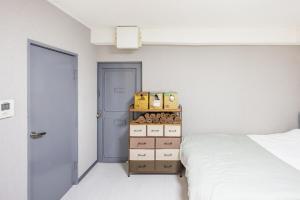 a bedroom with a bed and a shelf with boxes at Roppongi 3min Walk, Shinjuku 10min,Shibuya 15min, Tokyo Tower 58sqm for 6 in Tokyo