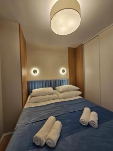 a bedroom with a large bed with towels on it at Sileo Apart No.85 in Ustka +126 photos