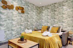 a living room with two tables and a couch at Bluestay 189- Charming apartment in Asnieres in Asnières-sur-Seine
