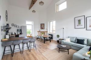 a living room with a couch and a table at Treize Maison B-2 bed house in centre of Saint Severin in Saint-Séverin