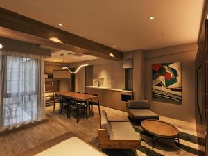 a living room with a table and a kitchen at illi Mia Kinshicho in Tokyo +39 photos