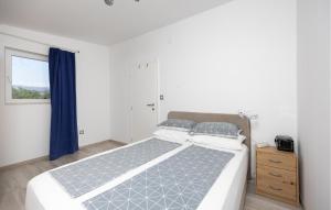 a bedroom with a large bed and a window at Nice Apartment In Slime With Wifi in Slime