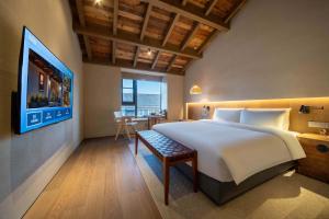 Postel nebo postele na pokoji v ubytování YUANLI HOTEL