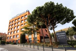 a building with a tree in front of a street at Abba Garden in Barcelona