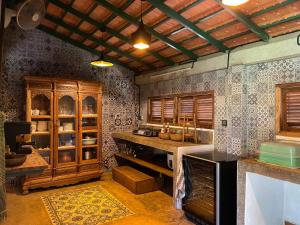 a kitchen with wooden cabinets and a counter top at Mlis Kampot River in Kampot