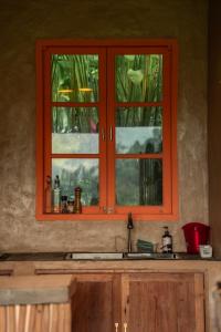 a kitchen with an orange window above a sink at Ravelyn House in Silebeng +26 photos