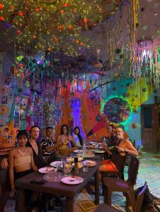 a group of people sitting at a table in a restaurant at Jonny's Hostel in San Juan