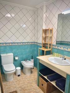 a bathroom with a toilet and a sink at Ático Sun&Beach Fuerteventura in Gran Tarajal +18 photos
