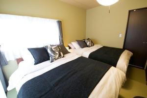 En eller flere senge i et værelse på Realization INN Horikiri