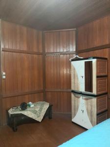 a room with a refrigerator and a table in it at Pairi's Family Homestay in Rantepao +19 photos
