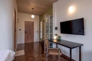 a living room with a table and a tv on the wall at MornSamyan in Bang Rak