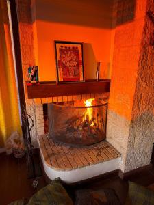 a brick fireplace with a fire in it at Veranda Villa in Arachova