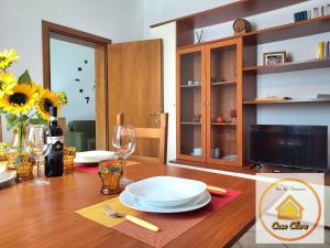 a dining room table with plates and glasses on it at Casa Clara in Cerreto Guidi