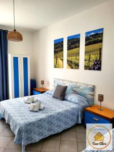 a bedroom with a bed and paintings on the wall at Casa Clara in Cerreto Guidi