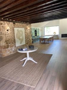 a living room with a table and a stone wall at El Molino del Burgo de Osma in El Burgo de Osma +33 photos
