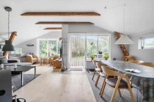 a dining room and living room with a table and chairs at 6814-Hasle-Toftegardsvej-20-F in Hasle
