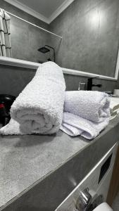 a white towel sitting on a counter in a bathroom at 2 room apartment, ЖК Кристалл in Almaty +37 photos